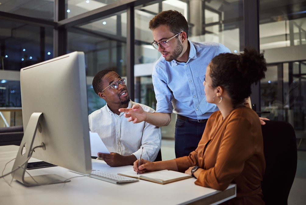 Three colleagues having a work discussion