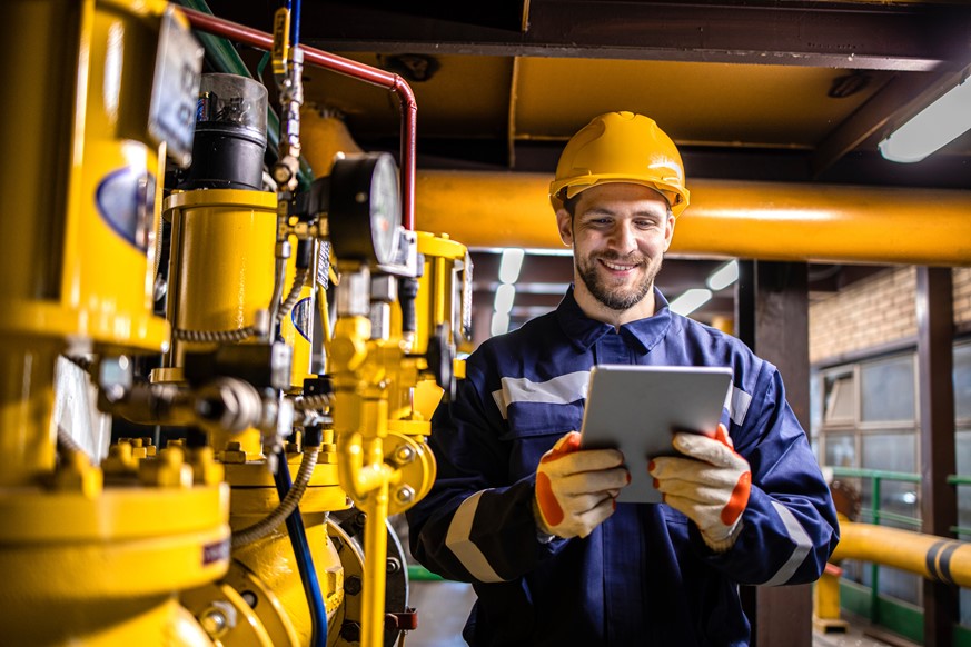 An engineer holding a tablet at work