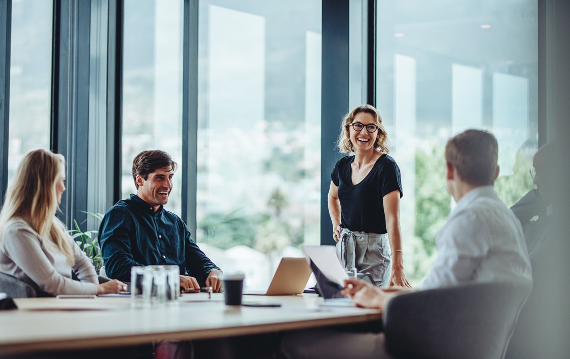 Project administrators and managers discussing project status in an office